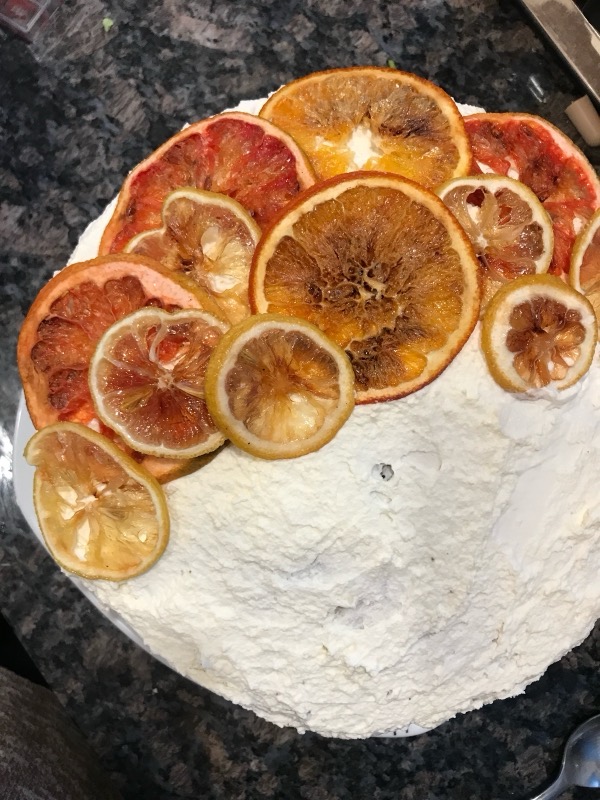 Chocolate cake with whipped cream frosting and dried citrus